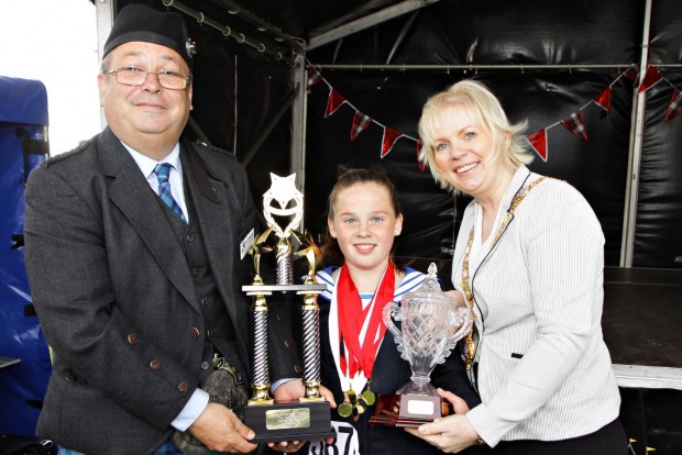 Pictured is Mayor of Causeway Coast and Glens Borough Council, Councillor Michelle Knight-McQuillan with Chairman of The Royal Scottish Pipe Band Association Northern Ireland, Ray Hall and prize winner at the competition which was part of the weekend of events during the North West Pipe Band Championships, Portrush. 