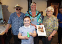 Deputy Mayor of Causeway Coast and Glens Borough Council, Alderman Sandra Hunter with Peter Molloy from the Friends' of Ballycastle Museum, P5 pupil, Ava, from Ballycastle Integrated Primary School along with her Young Historian project, "Ballycastle in the Past....according to my Granny", and her Granny Betty.