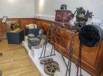 Cinema objects from Coleraine and Ballymoney Museum collections, including projectors,  film reels, tickets and a confectionery tray