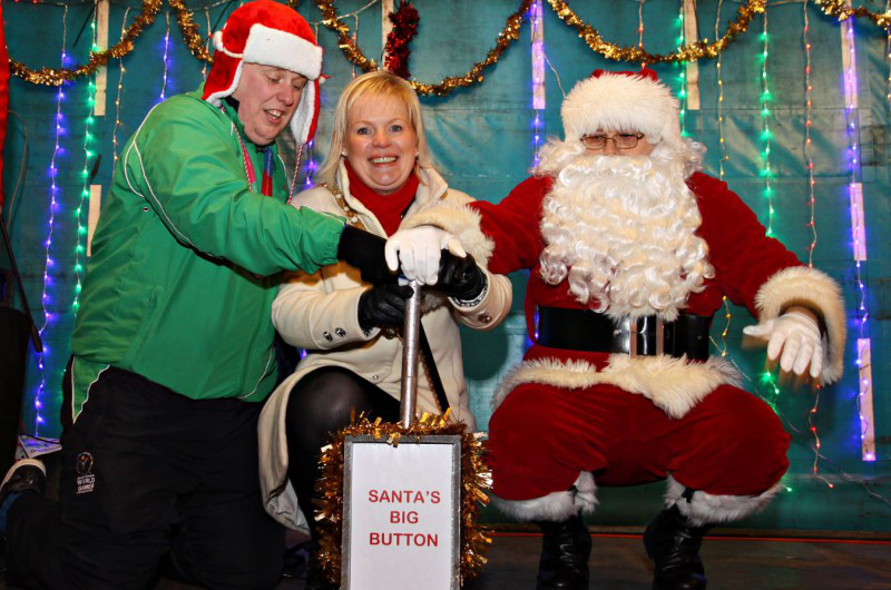 Santa with Mayor of Causeway Coast and Glens Borough Council, Councillor Michelle Knight-McQuillan and Special Olympian, Sean Campbell push the button at the Diamond in Coleraine to light up the town for Christmas.