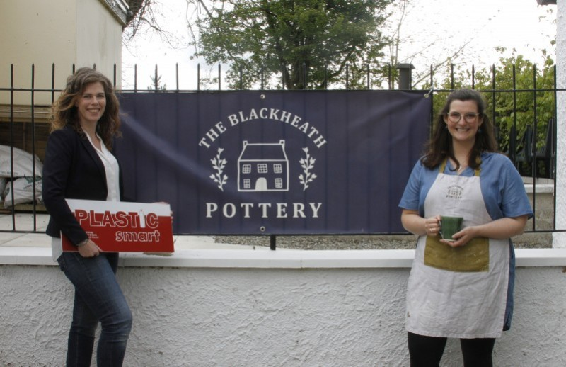 Babs Belshaw, potter, at Blackheath Pottery and Coffee shop promoting H2O On the Go free water bottle refills as part of their PlasticSmart awarded business practices, with Fiona Watters, Environmental Resource Officer