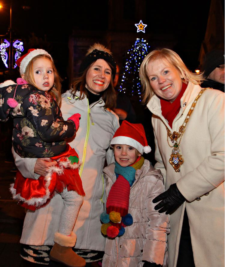 Mayor of Causeway Coast and Glens Borough Council, Councillor Michelle Knight-McQuillan with the Hasson family mum Jacqueline, Molly and Niamh at the Diamond in Coleraine for the switch on of the Christmas Lights.mas Lights.