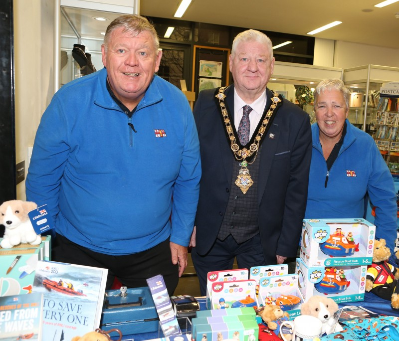 Mayor of Causeway Coast and Glens, Councillor Steven Callaghan, pictured at a fundraising event with two members of the RNLI. They pictured at the RNLI shop stall.