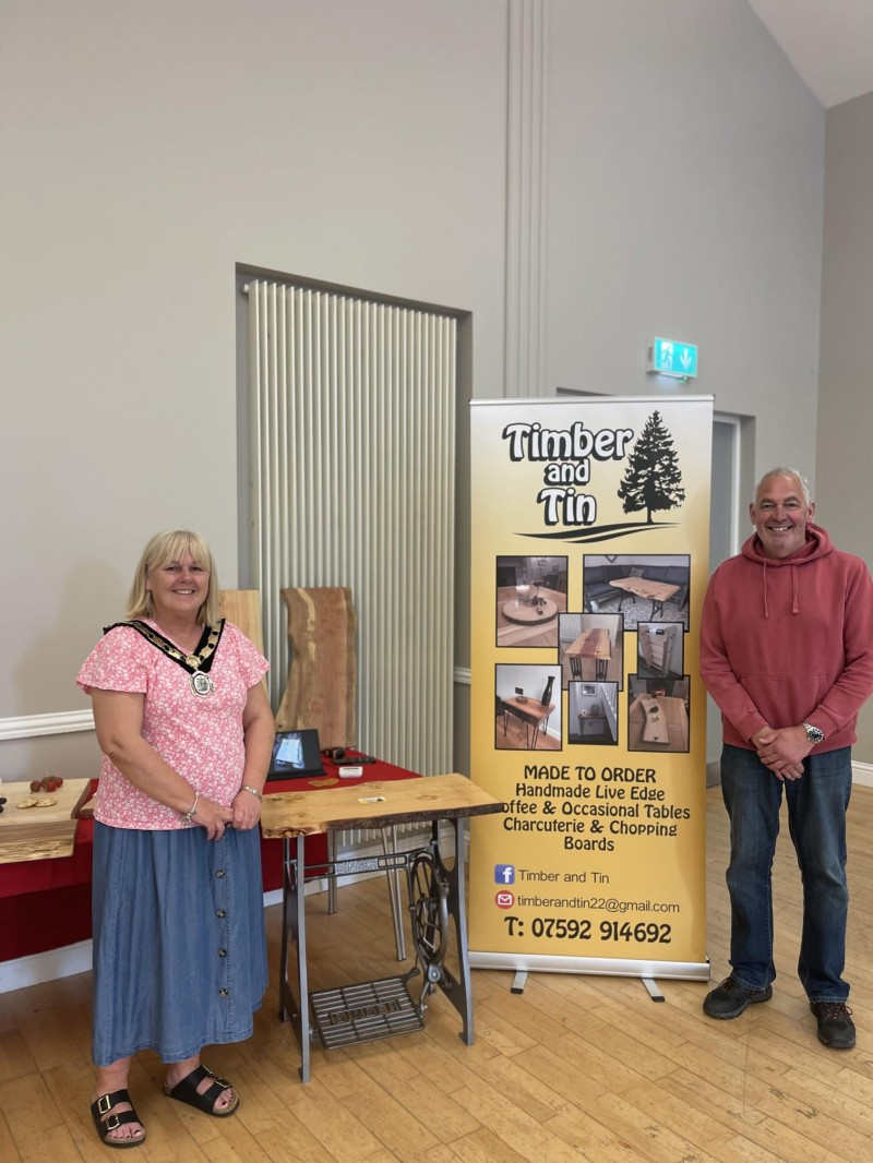 Deputy Mayor of Causeway Coast and Glens, Margaret Anne-McKillop pictured alongside owner of the Timber and Tin company with his products at the recent May Market for RNLI.