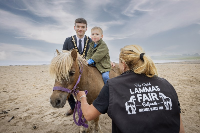 Causeway Coast and Glens Mayor Councillor Ciarán McQuillan and Melissa Lemon, Chief Horse Steward with her grandson Caolan, and Topper who will be with the Riding for Disabled team at Fairhill Street on Monday and Tuesday of the fair.