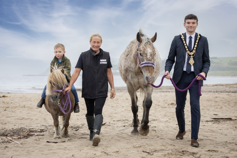 Causeway Coast and Glens Mayor Councillor Ciarán McQuillan and Melissa Lemon, Chief Horse Steward with her grandson Caolan, and Topper the pony and Katey P the beautiful Appaloosa horse.