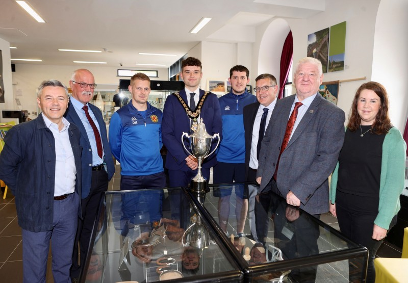 Mayor of Causeway Coast and Glens Councillor Ciarán McQuillan at the unveiling of a new football themed display in Roe Valley Arts and Cultural Centre pictured alongside (l-r) Alan Robinson MLA, Alderman Edgar Scott, David Miller, Thomas Reid, David Reid, Councillor Steven Callaghan and Sarah Calvin, Museum Services Development Manager.