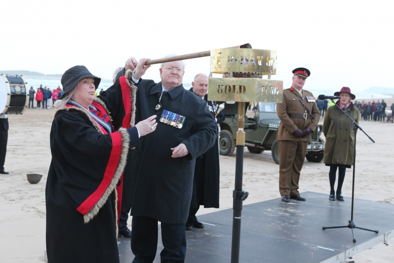 County Antrim Deputy Lord Lieutenant Colonel Dr Stephen Bailie accompanied by Alderman Michelle Knight-McQuillan, chair of the Garvagh branch of the Royal British Legion, lighting the commemorative D-Day beacon.