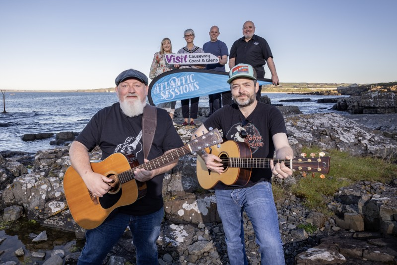 Deputy Mayor of Causeway Coast and Glens, Councillor Tanya Stirling joins with, Joanne Boyle GM of Elephant Rock Hotel Portrush, Mark Sheppard (Get Shep) and Danny Coyles of the Station Bar Portrush. While Paddy Nash and Junior Johnston are pictured with guitars at the ready as the line up for November 2024 Atlantic Sessions is announced.