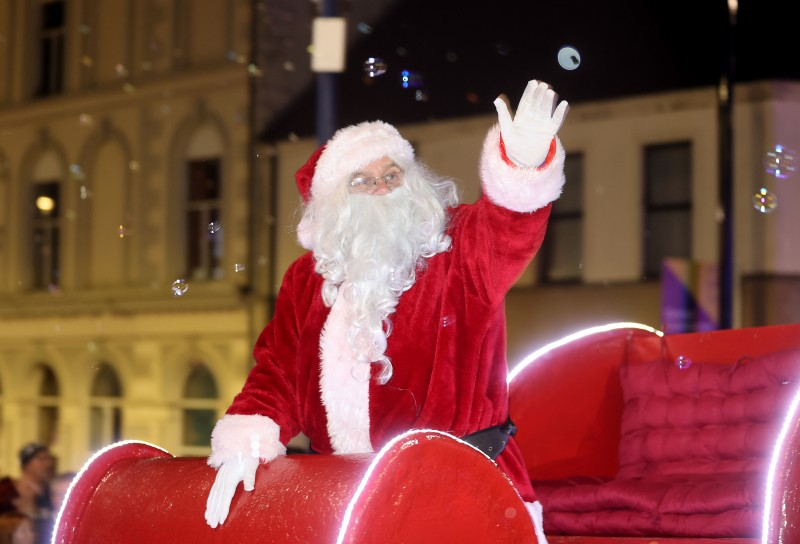 Santa arriving at the Christmas Light Switch On event in Coleraine, waving to the crowds lined along the route.