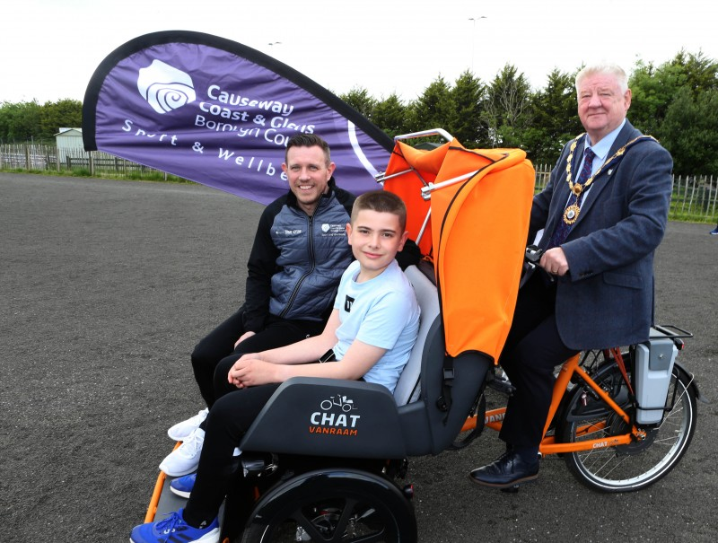 The Mayor, Cllr Steven Callaghan, alongside Council’s Sport and Wellbeing Development Manager Jonathan McFadden and a child. They are pictured in one of Council’s brand-new inclusive bicycles.