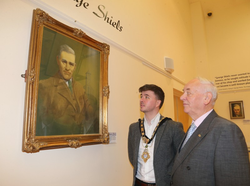 The Mayor of Causeway Coast and Glens Borough Council Councillor Sean Bateson pictured with Mac Pollock from Ballymoney Drama Festival as they admire the original George Shiels portrait by Jack Wilkinson on loan from the Abbey Theatre in Dublin.