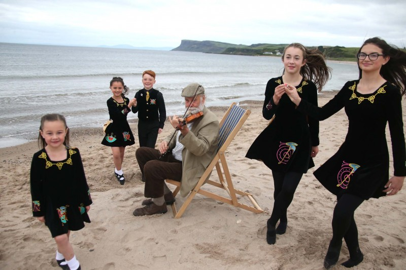 Pictured against the beautiful backdrop of Fairhead are Roma, Eva, Gavin, Alice and Ana from the Lir School of Irish Dancing with musician Dick Glasgow, looking ahead to the seafront entertainment at the Auld Lammas Fair.