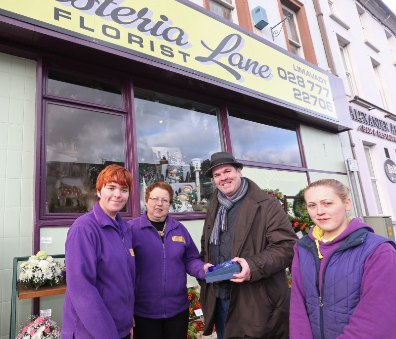 Rebecca Whitelaw, Audrey Wilson and Victoria Wilson of Wisteria Lane florists receive their second place prize from Causeway Coast and Glens Borough Council Officer Shaun Kennedy.