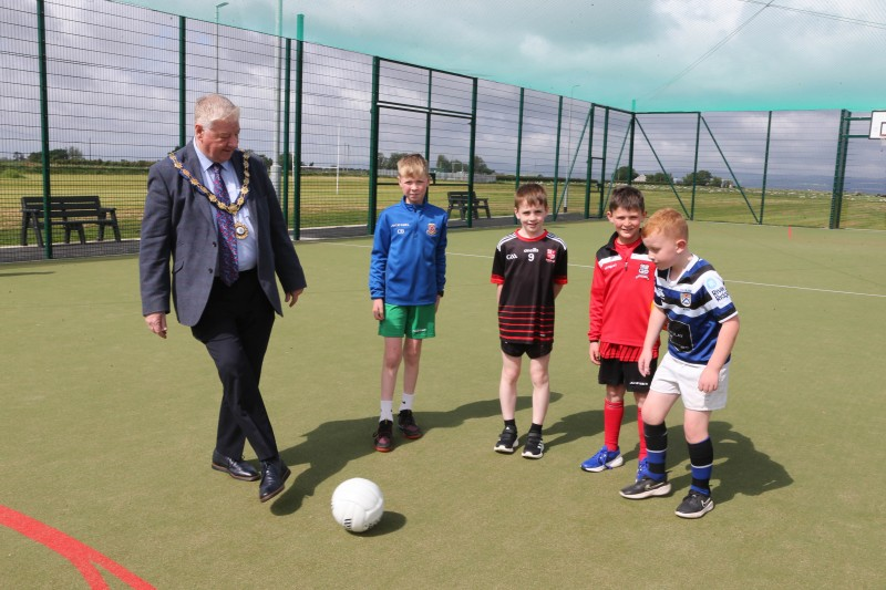 Mayor, Councillor Steven Callaghan plays football with pupils from St Aidan’s Primary School, Magilligan.