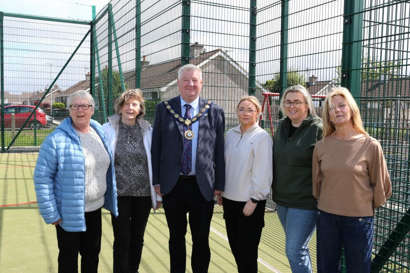 Mayor of Causeway Coast and Glens, Councillor Steven Callaghan with local volunteers at the newly unveiled multi-use games area in Magilligan.