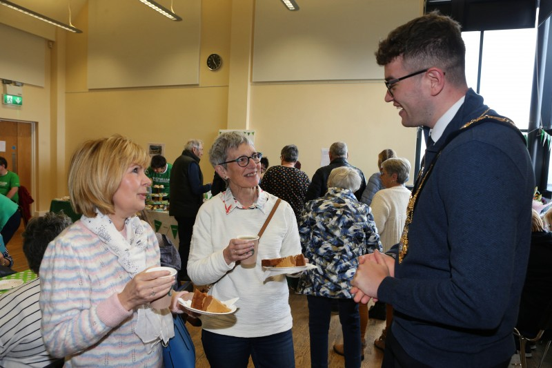 Carol Donaghy and Aileen Gault enjoying coffee and cake while chatting to the Mayor of Causeway Coast and Glens, Councillor Ciarán McQuillan