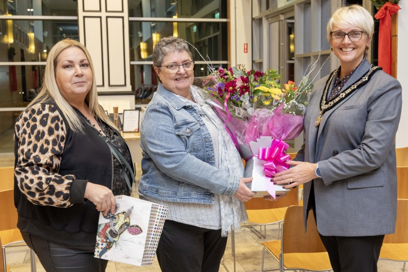 Deputy Mayor of Causeway Coast and Glens, Councillor Tanya Stirling presenting flowers to Mary Gibson, Chairperson and Patricia McQuillan MBE, Secretary of Moneydig Rural Network at a reception to recognise the efforts of Moneydig Park, who have won two NIAC ‘Best Kept Awards’.