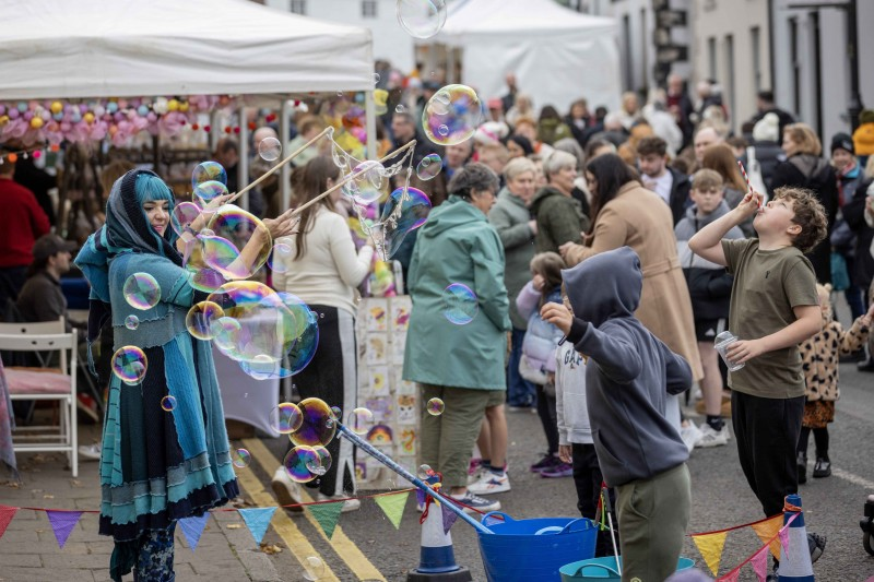 Street performers and crowds of visitors at this year's Salmon and Whiskey Festival.