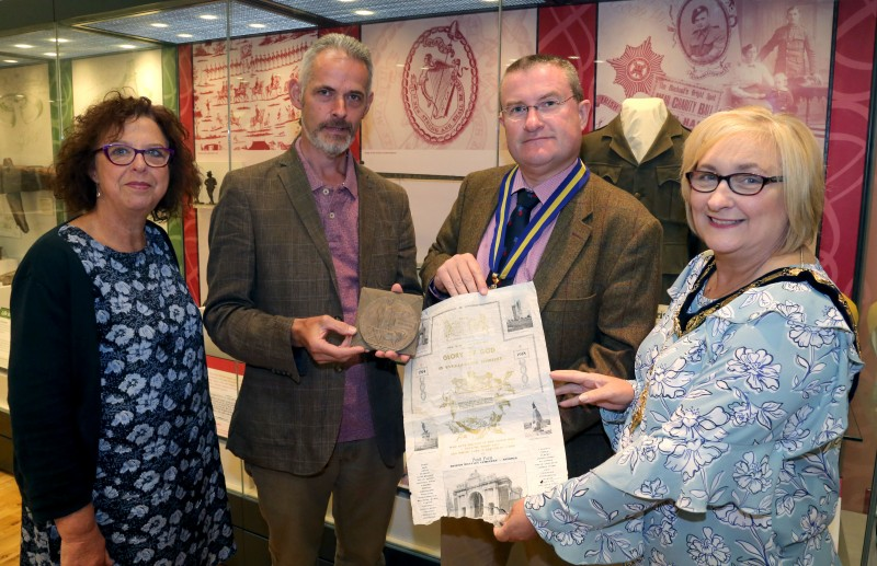Helen Perry, Causeway Coast and Glens Borough Council Museums Service, Andrew Barrett, finder of the items,  Mark McLaughlin, Chair of Ballymoney Royal British Legion and the Mayor of Causeway Coast and Glens Borough Council Councillor Brenda Chivers with the Death Penny and the Pond Farm Cemetery certificate which belonged to Private John Hanna from Ballymoney.