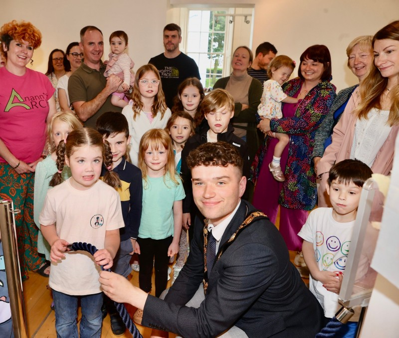 Mayor of Causeway Coast and Glens Councillor Ciarán McQuillan meeting a group of local families at the launch of the “Cardboard Coast Town” exhibition in Flowerfield Arts Centre.