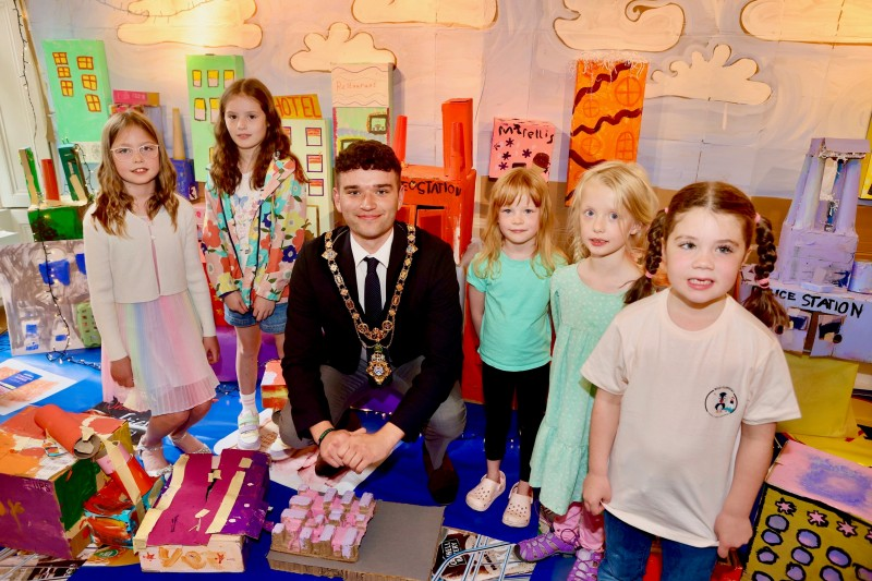 Mayor of Causeway Coast and Glens Councillor Ciarán McQuillan pictured with a group of local children who were involved in creating the “Cardboard Coast Town” exhibition in Flowerfield Arts Centre.