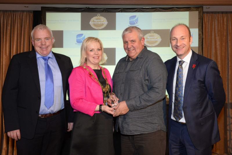 Causeway Coast and Glens Borough Council’s Sports Awards 2015, was presented in the Lodge Hotel Coleraine on 7th November 2015. Winner of the Sports Administrator Award is Maurice McAlister presented by Mayor of Causeway Coast and Glens Borough Council, Councillor Michelle Knight McQuillan, with compere for the evening Stephen Watson, and sponsored by David Boyd of Roadside Garages, Coleraine. For more information go to www.causewaycoastandglens.gov.uk.