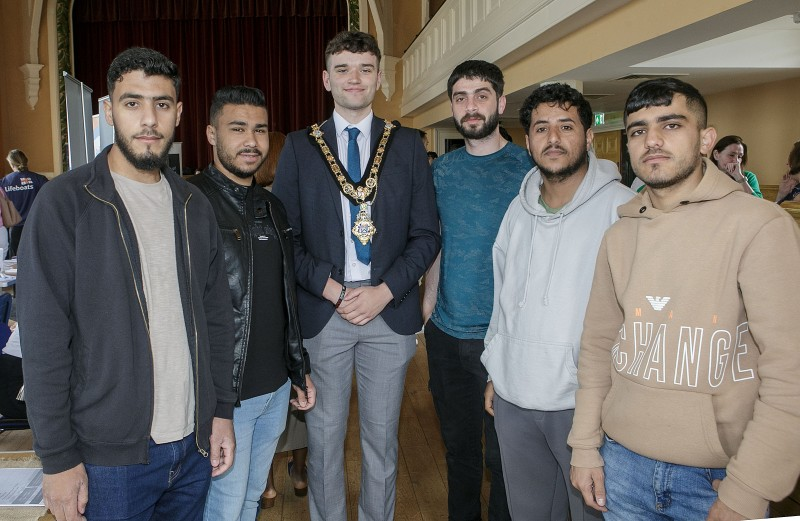 The Mayor of Causeway Coast and Glens, Councillor Ciaran McQuillan, at the Information event in Portrush Town Hall, pictured alongside asylum seekers from the Borough.