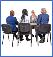 A group of people sitting around a table as part of an interview