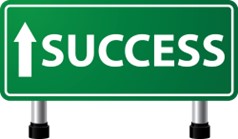 a green direction sign with the word success and an arrow pointing the way